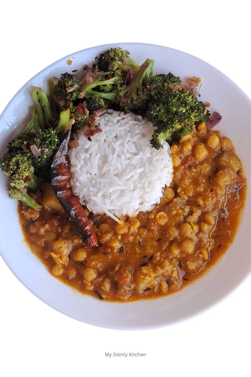 chana dal curry served with rice and broccoli on a white plate