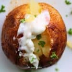 Close up baked potato with cream on top - What to serve with baked potatoes feature image