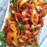 Fajita veggies displayed on a white plate